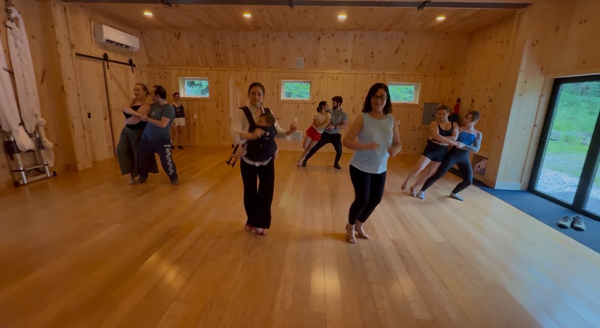 Students dancing together in a ballroom studio.